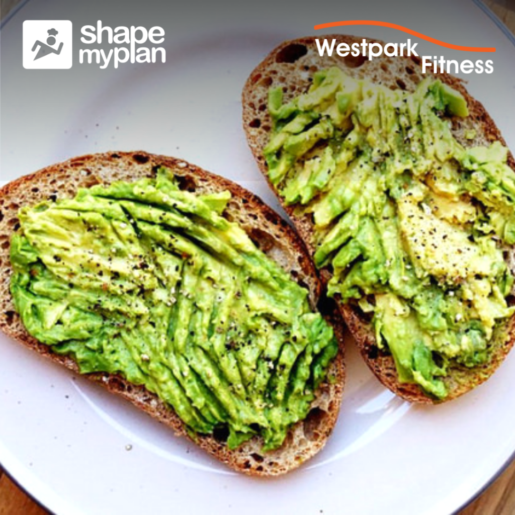 avocado toast recipe at westpark fitness two pieces of bread covered in mashed avocado on a white plate