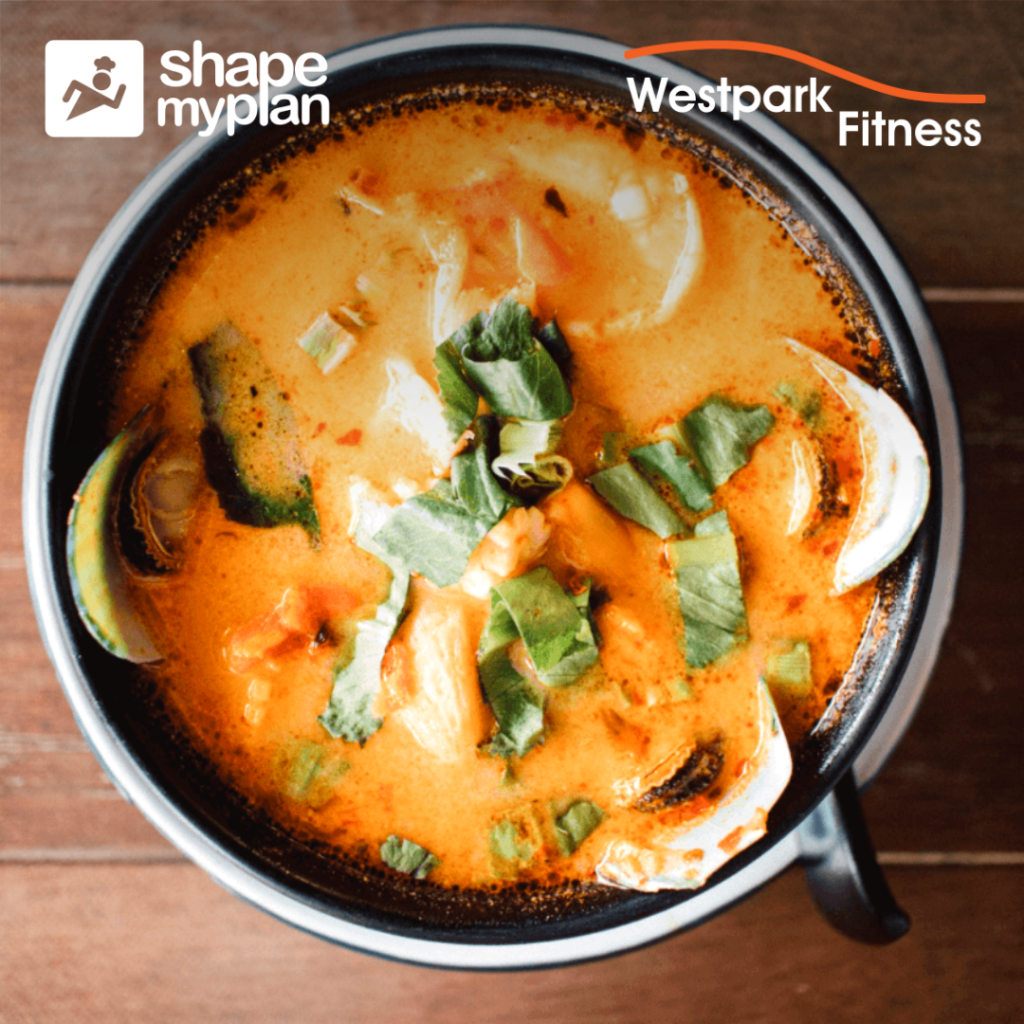 creamy prawns on a round plate filled with orange coloured sauce and vegetable slices at westpark fitness