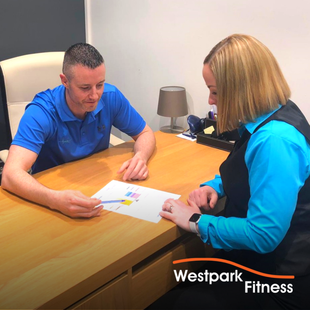 metabolic testing in dublin 24 at westpark fitness with health matters man and woman sitting opposite each other at a desk both looking at a sheet of paper