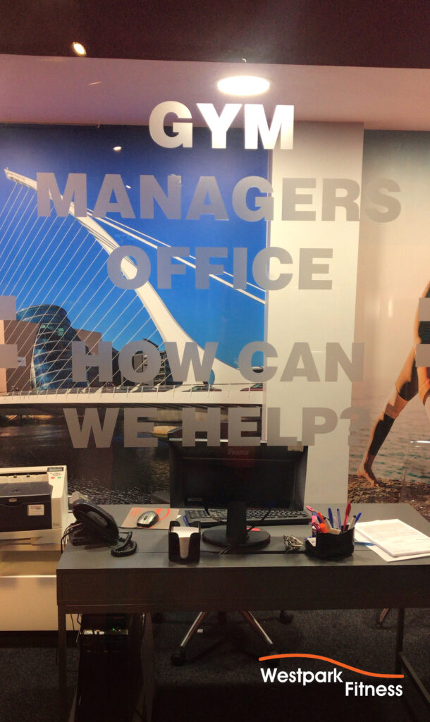 choose westpark fitness glass window of gym managers off with stickers that read gym managers office how can we help