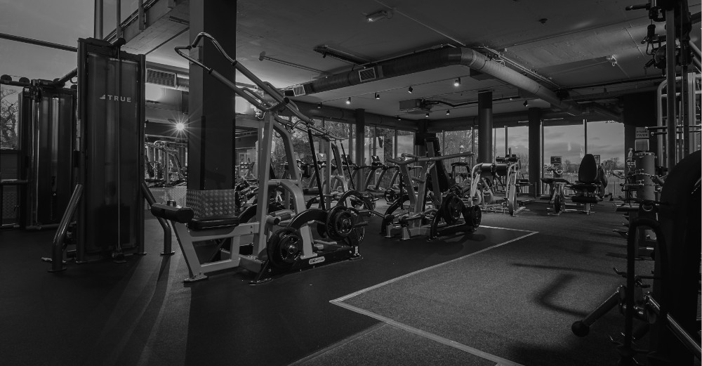 black white image of exercise equipment in a gym