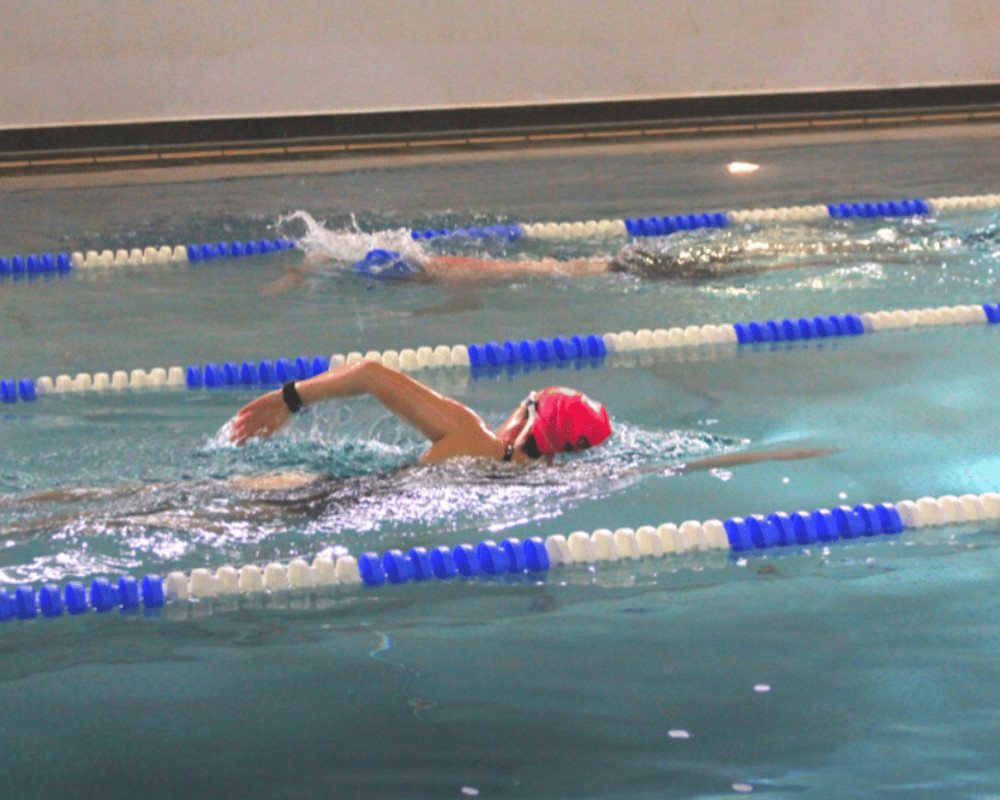 team of people training at a gym pool